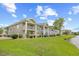 Attractive condo building exterior with lush landscaping and a beautiful water view at 4767 Wild Iris Dr. # 203, Myrtle Beach, SC 29579