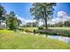 Scenic view of a golf course creek, surrounded by green grass and trees under a partly cloudy sky at 4767 Wild Iris Dr. # 203, Myrtle Beach, SC 29579