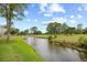 Beautiful golf course scene with a winding creek, lush green fairways, and mature trees, set against a blue sky at 4767 Wild Iris Dr. # 203, Myrtle Beach, SC 29579