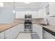 Bright kitchen with stainless steel appliances, granite counters, stylish backsplash, and ample cabinet space at 4767 Wild Iris Dr. # 203, Myrtle Beach, SC 29579