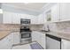 Well-equipped kitchen features stainless steel appliances, granite counters, and tiled backsplash at 4767 Wild Iris Dr. # 203, Myrtle Beach, SC 29579