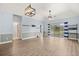Open living area featuring wood floors, modern lighting, and sliding glass doors at 4767 Wild Iris Dr. # 203, Myrtle Beach, SC 29579