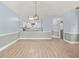 Bright living room view to kitchen with white cabinets, backsplash and pendant lighting at 4767 Wild Iris Dr. # 203, Myrtle Beach, SC 29579