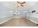 Open-concept living room with wood floors, a ceiling fan, and views to the bright kitchen at 4767 Wild Iris Dr. # 203, Myrtle Beach, SC 29579