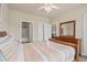 Comfortable bedroom with a queen bed, ceiling fan, and a dresser with mirror at 4890 Luster Leaf Circle # 201, Myrtle Beach, SC 29577