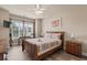 Cozy bedroom with a queen bed, natural light from a window, ceiling fan, and wood-style flooring at 4890 Luster Leaf Circle # 201, Myrtle Beach, SC 29577