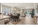 Cozy dining area with modern chandelier and view into the living room with patio access at 4890 Luster Leaf Circle # 201, Myrtle Beach, SC 29577