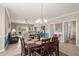Charming dining area with chandelier, view of living room, and access to outdoor patio at 4890 Luster Leaf Circle # 201, Myrtle Beach, SC 29577
