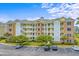 Beautiful multi-story condo building with yellow and brick accents and lush landscaping at 4890 Luster Leaf Circle # 201, Myrtle Beach, SC 29577