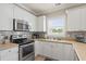 Kitchen with stainless steel appliances, white cabinets, and bright natural light at 4890 Luster Leaf Circle # 201, Myrtle Beach, SC 29577