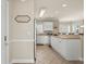 Bright kitchen featuring white cabinetry, a breakfast bar, and neutral countertops at 4890 Luster Leaf Circle # 201, Myrtle Beach, SC 29577