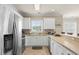 Well-lit kitchen featuring stainless steel appliances and white cabinets with stylish backsplash at 4890 Luster Leaf Circle # 201, Myrtle Beach, SC 29577