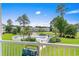 Scenic view from the balcony showcasing the community pool, lush landscaping, and nearby buildings at 4890 Luster Leaf Circle # 201, Myrtle Beach, SC 29577