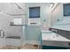 Bright bathroom with double sinks, custom cabinets, and sleek shower with herringbone tile at 4900 N Ocean Blvd., Myrtle Beach, SC 29577