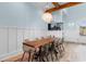 Elegant dining room with modern chairs, a wooden table, a unique chandelier, and an aquarium feature at 4900 N Ocean Blvd., Myrtle Beach, SC 29577