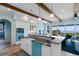 Gourmet kitchen with a farmhouse sink, island, breakfast bar, exposed beams, and ocean views at 4900 N Ocean Blvd., Myrtle Beach, SC 29577
