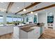 Gourmet kitchen with a farmhouse sink, island, breakfast bar, exposed beams, and ocean views at 4900 N Ocean Blvd., Myrtle Beach, SC 29577