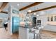 Stylish kitchen featuring an island with seating, custom cabinetry, and retro-inspired blue appliances at 4900 N Ocean Blvd., Myrtle Beach, SC 29577