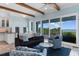 Bright living room boasts wood beams, ocean views, and a cozy seating arrangement perfect for relaxing at 4900 N Ocean Blvd., Myrtle Beach, SC 29577