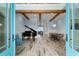 Bright and airy living room featuring wood flooring, a grand piano, and beams for architectural detail at 4900 N Ocean Blvd., Myrtle Beach, SC 29577