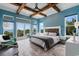 Relaxing bedroom with ocean view, wood beams, and comfortable seating area perfect for unwinding at 4900 N Ocean Blvd., Myrtle Beach, SC 29577