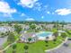 A stunning aerial view of the neighborhood pool, community center, and surrounding residences at 503 20Th Ave. N # 15B, North Myrtle Beach, SC 29582