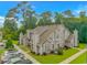 Exterior view of a two-story townhome with grey siding, a patio, and green landscaping at 503 20Th Ave. N # 15B, North Myrtle Beach, SC 29582