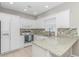 Well-equipped kitchen with white cabinets, granite countertops, stainless steel appliances, and tile backsplash at 503 20Th Ave. N # 15B, North Myrtle Beach, SC 29582