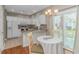 Modern kitchen featuring white cabinetry, granite countertops, and a cozy breakfast nook near sliding glass doors at 503 20Th Ave. N # 15B, North Myrtle Beach, SC 29582