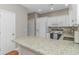 Bright kitchen showcasing granite countertops, white cabinetry, stainless appliances, and hardwood floors at 503 20Th Ave. N # 15B, North Myrtle Beach, SC 29582