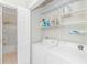 Convenient laundry room with washer, dryer, and wire shelving for storage at 503 20Th Ave. N # 15B, North Myrtle Beach, SC 29582