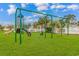 Community playground with swings and slide situated on lush green lawn at 503 20Th Ave. N # 15B, North Myrtle Beach, SC 29582