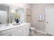 Elegant bathroom with dual sinks, white cabinets, and decorative wall art at 5039 Selene Ct., Myrtle Beach, SC 29588