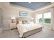 Comfortable bedroom features a tray ceiling, plush carpeting, and ample natural light at 5039 Selene Ct., Myrtle Beach, SC 29588