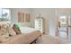 Cozy bedroom with neutral tones, a large window, and a view into the ensuite bathroom at 5039 Selene Ct., Myrtle Beach, SC 29588