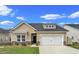 Charming home with a large garage, beautiful landscaping, and neutral colored siding at 5039 Selene Ct., Myrtle Beach, SC 29588