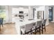 Kitchen with stainless appliances, large island with chairs, and an open floor plan at 5039 Selene Ct., Myrtle Beach, SC 29588