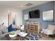 Stylish living room has a blue accent wall, entertainment center, and comfortable seating arrangement at 5039 Selene Ct., Myrtle Beach, SC 29588