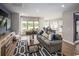 Bright living room boasts large windows, hardwood floors, and an open concept design with a kitchen view at 5039 Selene Ct., Myrtle Beach, SC 29588