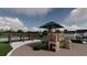 Community playground featuring a climbing structure, slide, and shaded seating area for residents to enjoy at 5039 Selene Ct., Myrtle Beach, SC 29588