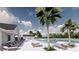 Community pool area with lounge seating, modern clubhouse, and beautifully landscaped palm trees creating an oasis at 5039 Selene Ct., Myrtle Beach, SC 29588