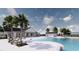Resort-style community pool area with palm trees, lounge chairs and modern clubhouse create an inviting atmosphere at 5039 Selene Ct., Myrtle Beach, SC 29588