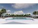 Large community pool with sunshades and lounge chairs, surrounded by landscaping and mature trees at 5039 Selene Ct., Myrtle Beach, SC 29588