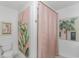 Colorful bathroom featuring modern artwork, pink shower curtain, and a toilet at 510 Rum Gully Rd., Murrells Inlet, SC 29576