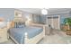 Coastal bedroom features seating area, television, light-blue walls, and modern light fixture at 510 Rum Gully Rd., Murrells Inlet, SC 29576