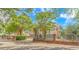 This is a charming two-story home features mature landscaping, a black metal fence, and a brick wall at 510 Rum Gully Rd., Murrells Inlet, SC 29576