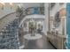 The grand foyer features a spiraling staircase, with custom carpet and high-end finishes and decor at 510 Rum Gully Rd., Murrells Inlet, SC 29576