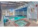 Indoor pool and hot tub area with natural light, blue accents, and basketball hoop at 510 Rum Gully Rd., Murrells Inlet, SC 29576