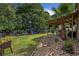 Large, fenced backyard featuring a patio, playset, and lush landscaping, perfect for Gathering fun at 5149 Morning Frost Pl., Myrtle Beach, SC 29579