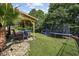 The backyard features a cozy covered patio with a dining set, a playground, and trampoline for outdoor fun at 5149 Morning Frost Pl., Myrtle Beach, SC 29579